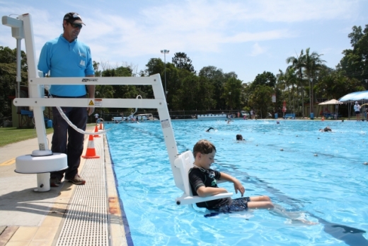 Mullumbimby Pool manager Mark Mathison helps demonstrate the equipment with his son, Clark.